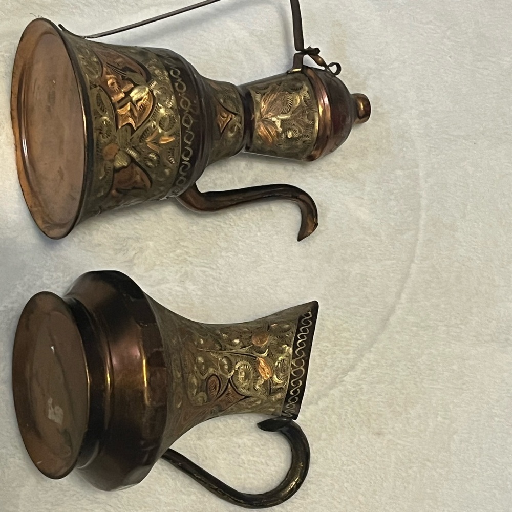 This is a pair of vintage Middle Eastern coffee or water pitchers.